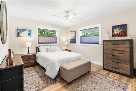 a bedroom with a bed and a chandelier