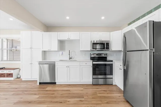 a kitchen with a refrigerator stove and microwave
