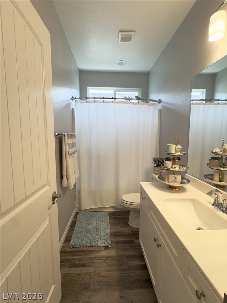 78 Summer Rhapsody Avenue Henderson, NV 89015 - Photo 15 of 31 Full bathroom with vanity, a shower with curtain, and dark wood-style flooring