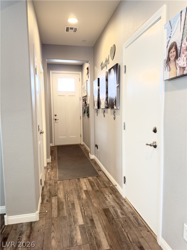 78 Summer Rhapsody Avenue Henderson, NV 89015 - Photo 17 of 31 Doorway to outside featuring hardwood / wood-style floors and baseboards