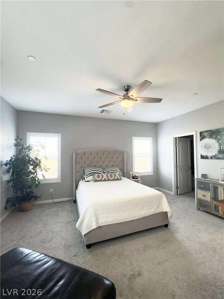 78 Summer Rhapsody Avenue Henderson, NV 89015 - Photo 21 of 31 Bedroom featuring light colored carpet and a ceiling fan