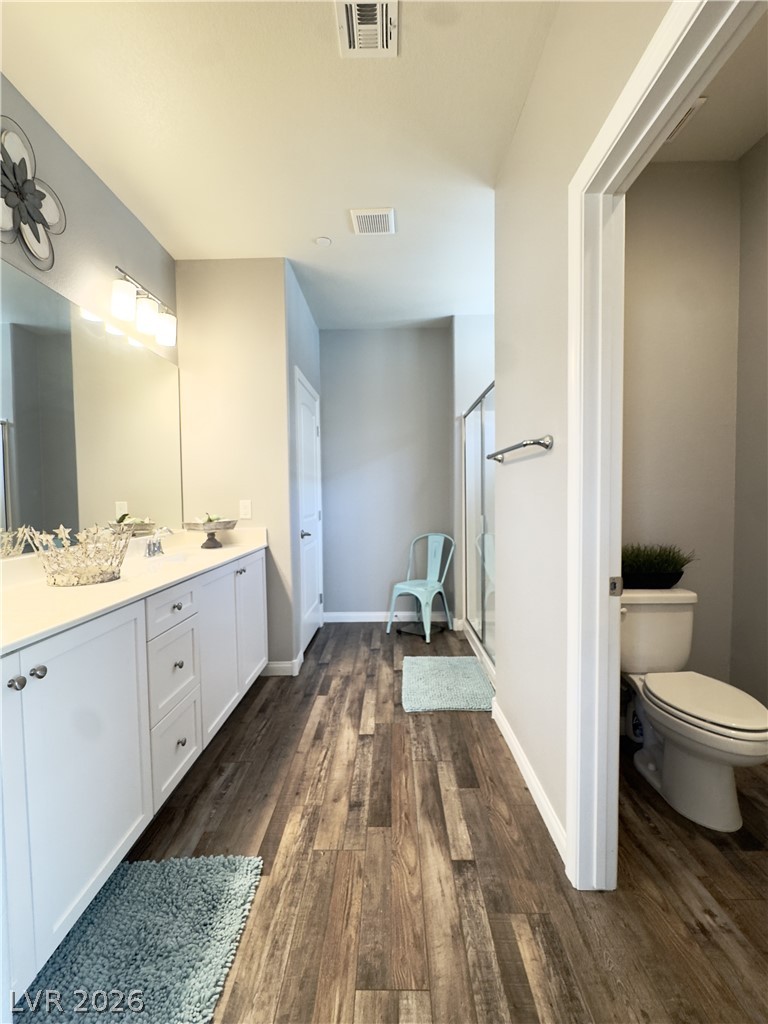 78 Summer Rhapsody Avenue Henderson, NV 89015 - Photo 23 of 31 Bathroom featuring dark wood-type flooring, double vanity, and a shower stall