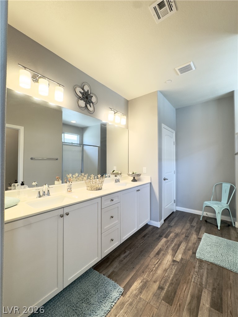 78 Summer Rhapsody Avenue Henderson, NV 89015 - Photo 24 of 31 Full bathroom featuring double vanity and dark wood-style flooring
