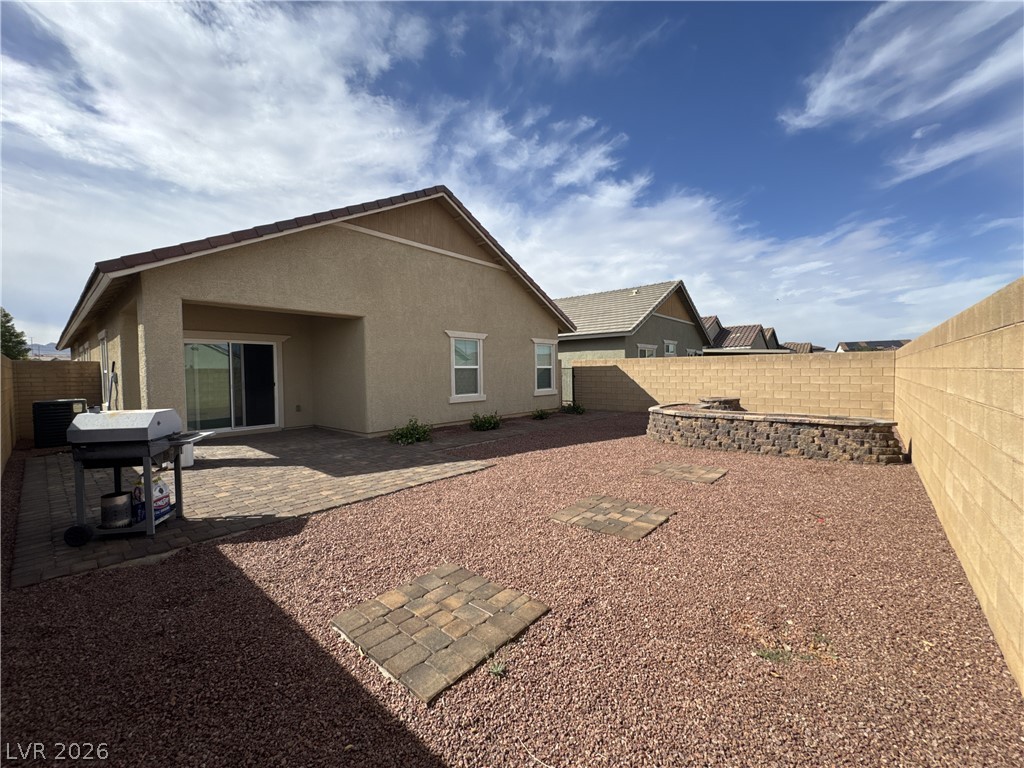 78 Summer Rhapsody Avenue Henderson, NV 89015 - Photo 28 of 31 Back of property featuring stucco siding, a fenced backyard, and a patio