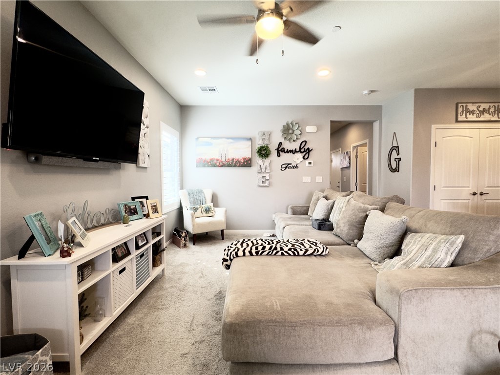 78 Summer Rhapsody Avenue Henderson, NV 89015 - Photo 8 of 31 Living area with a ceiling fan, light colored carpet, and recessed lighting