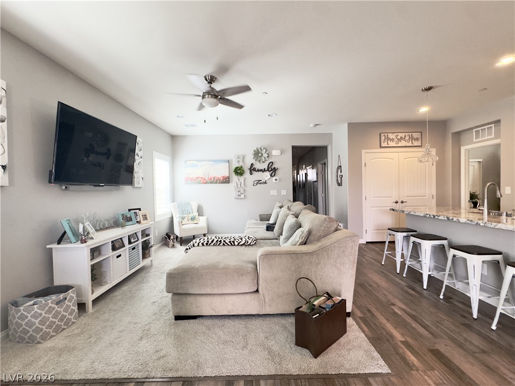 78 Summer Rhapsody Avenue Henderson, NV 89015 - Photo 9 of 31 Living area with a ceiling fan and dark wood-style floors