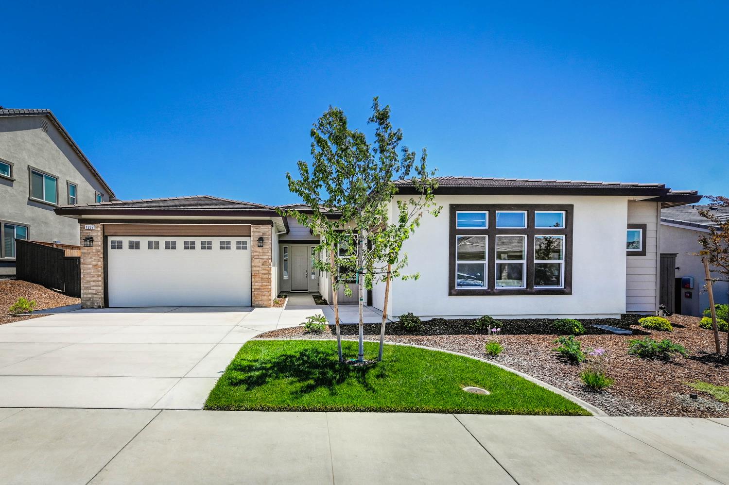 1207 Buck Ridge Drive Rocklin, CA 95765 - Photo 2 of 12 a front view of a house with garden