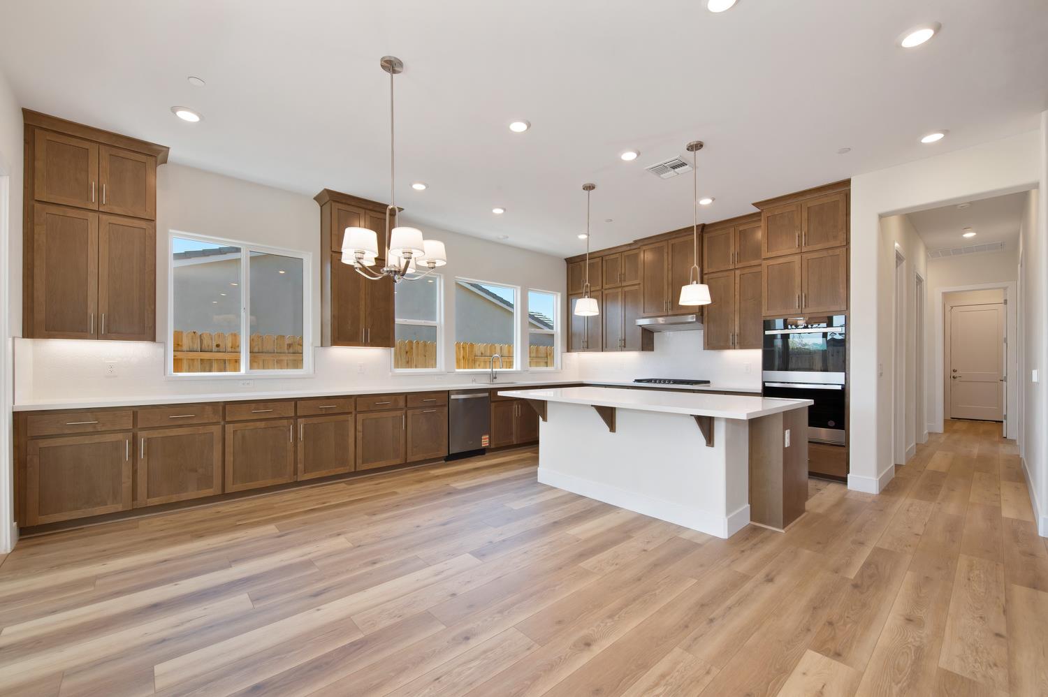 1207 Buck Ridge Drive Rocklin, CA 95765 - Photo 3 of 12 a large kitchen with a large counter top a sink stainless steel appliances and cabinets