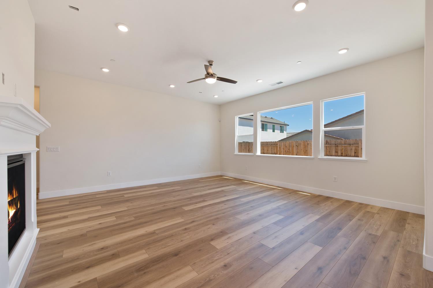 1207 Buck Ridge Drive Rocklin, CA 95765 - Photo 5 of 12 a view of an empty room with wooden floor fireplace and a window