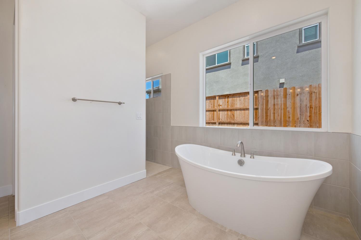 1207 Buck Ridge Drive Rocklin, CA 95765 - Photo 7 of 12 a white bath tub sitting next to a white sink