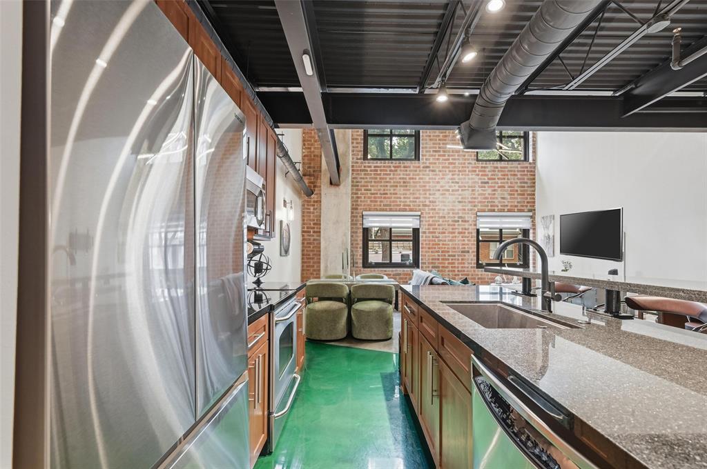 3110 Thomas Avenue, Unit 105 Dallas, TX 75204 - Photo 11 of 37 a kitchen with stainless steel appliances a sink a stove and a refrigerator