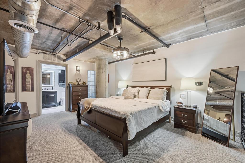 3110 Thomas Avenue, Unit 105 Dallas, TX 75204 - Photo 19 of 37 a large bed sitting in a room next to a window