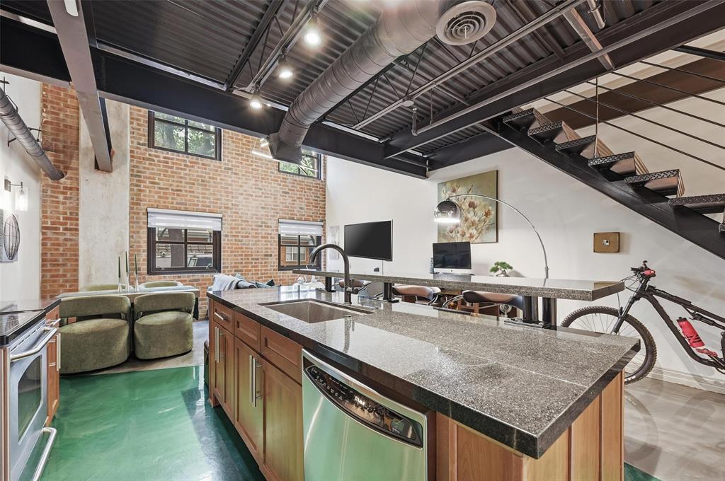 3110 Thomas Avenue, Unit 105 Dallas, TX 75204 - Photo 6 of 37 a kitchen with stainless steel appliances granite countertop a sink a stove and cabinets