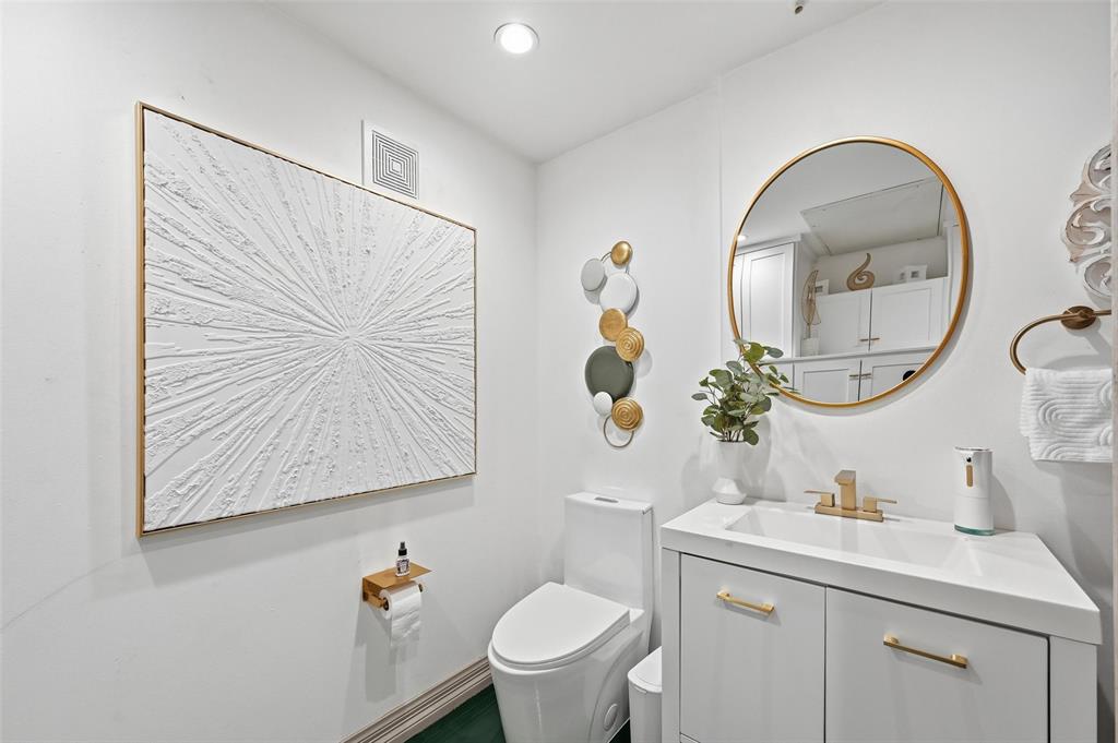 3110 Thomas Avenue, Unit 105 Dallas, TX 75204 - Photo 8 of 37 a bathroom with a toilet sink and mirror
