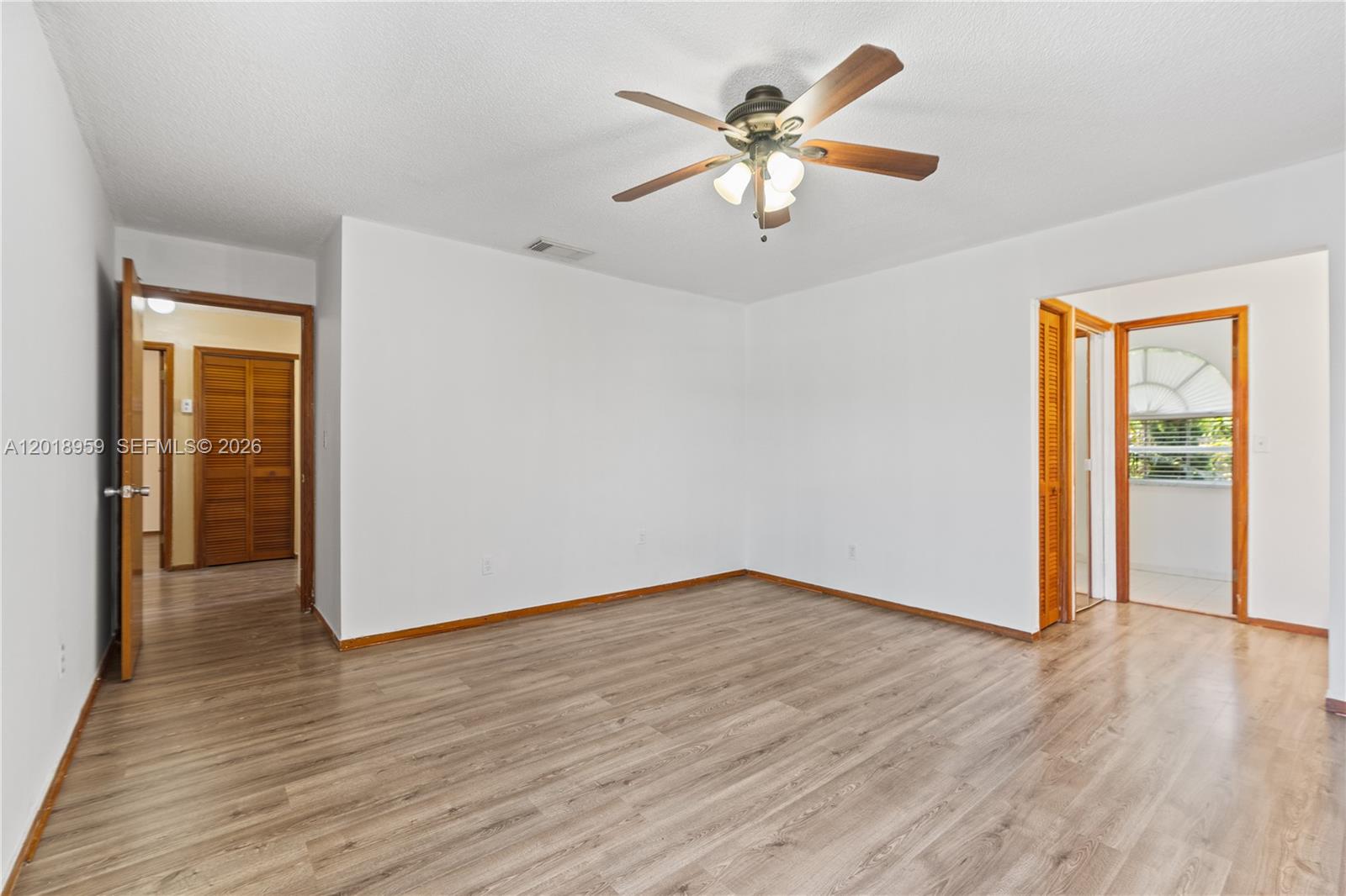 15345 Southwest 63rd Terrace Miami, FL 33193 - Photo 19 of 51 wooden floor in an empty room with a window