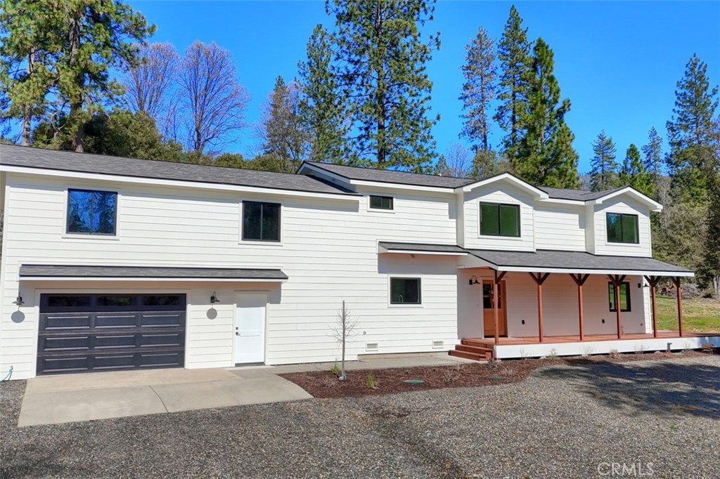 3181 B Triangle Park Road Mariposa, CA 95338 - Photo 1 of 44 a view of a white house with large windows and a small yard