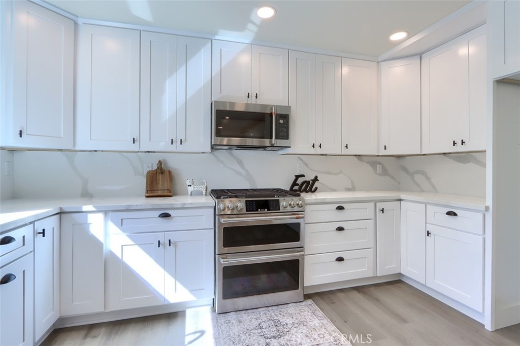 3181 B Triangle Park Road Mariposa, CA 95338 - Photo 10 of 44 a kitchen with granite countertop white cabinets and stainless steel appliances