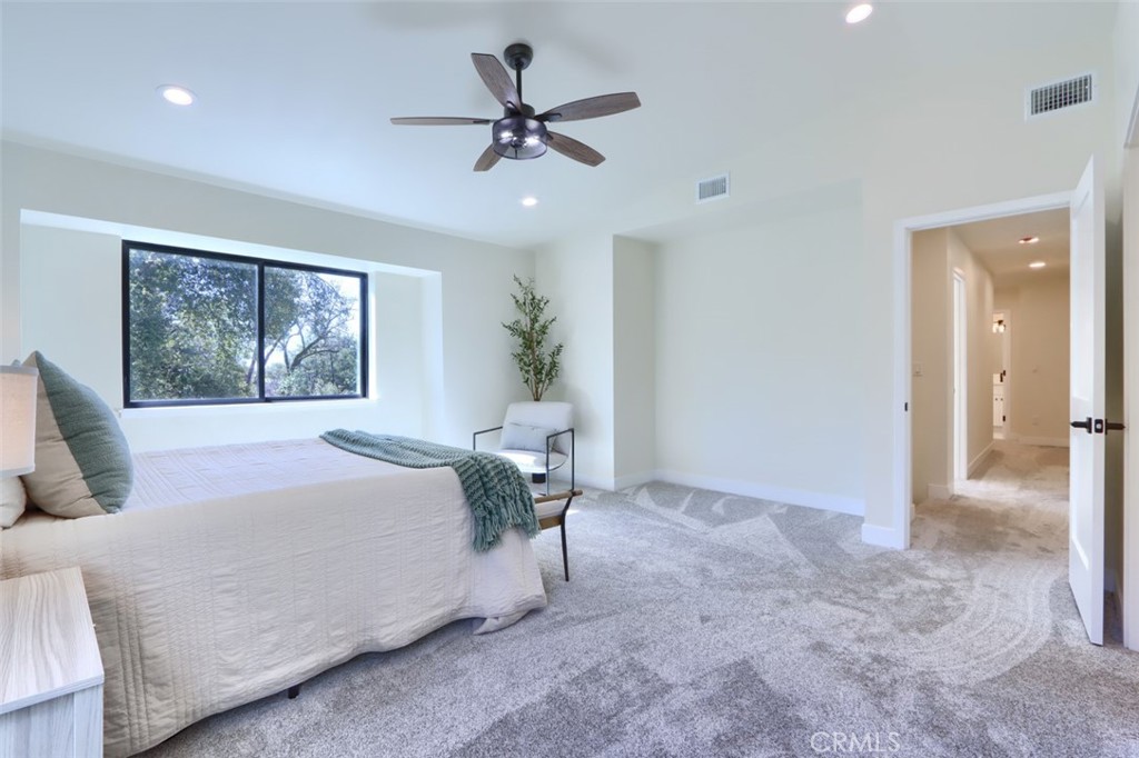 3181 B Triangle Park Road Mariposa, CA 95338 - Photo 20 of 44 a bedroom with a large bed chandelier and a window