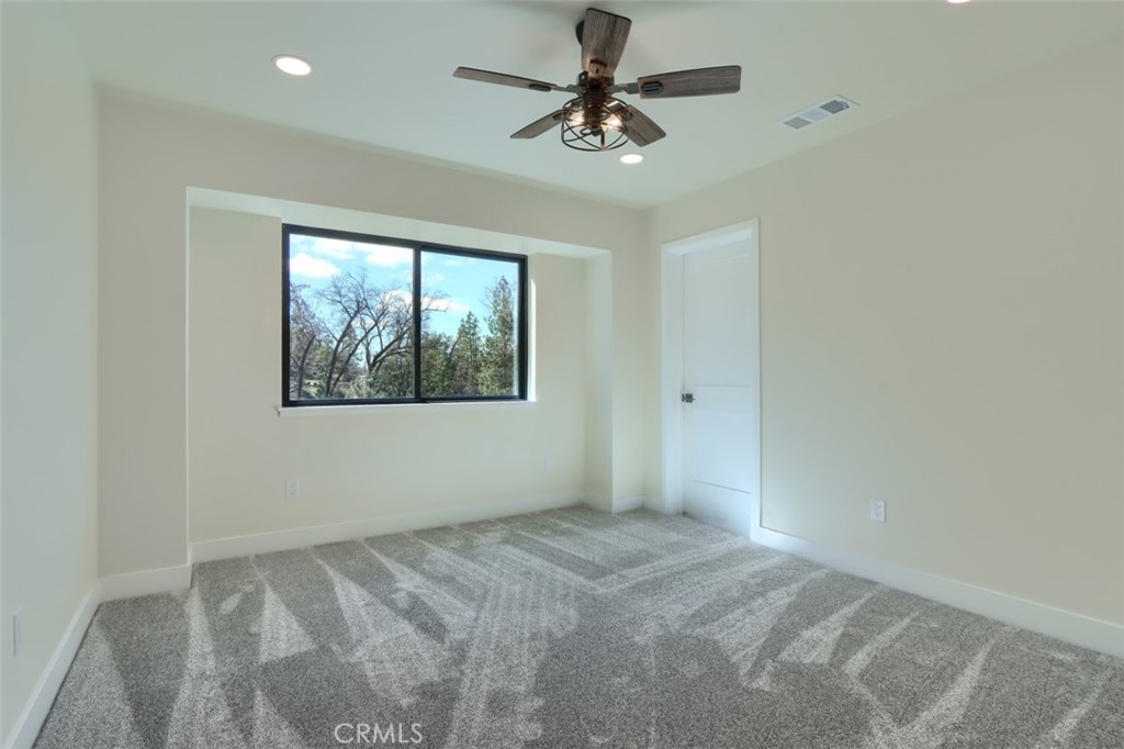3181 B Triangle Park Road Mariposa, CA 95338 - Photo 24 of 44 an empty room with a window and a fan