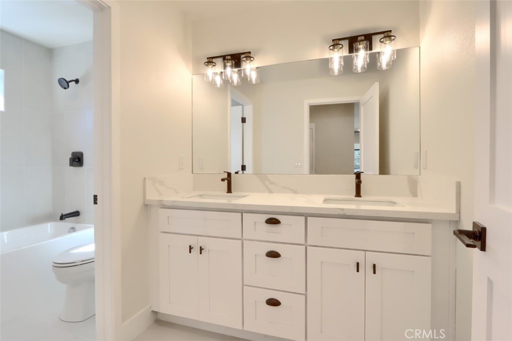 3181 B Triangle Park Road Mariposa, CA 95338 - Photo 29 of 44 a bathroom with a double vanity sink and a mirror