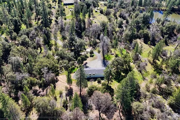 an aerial view of house with a street