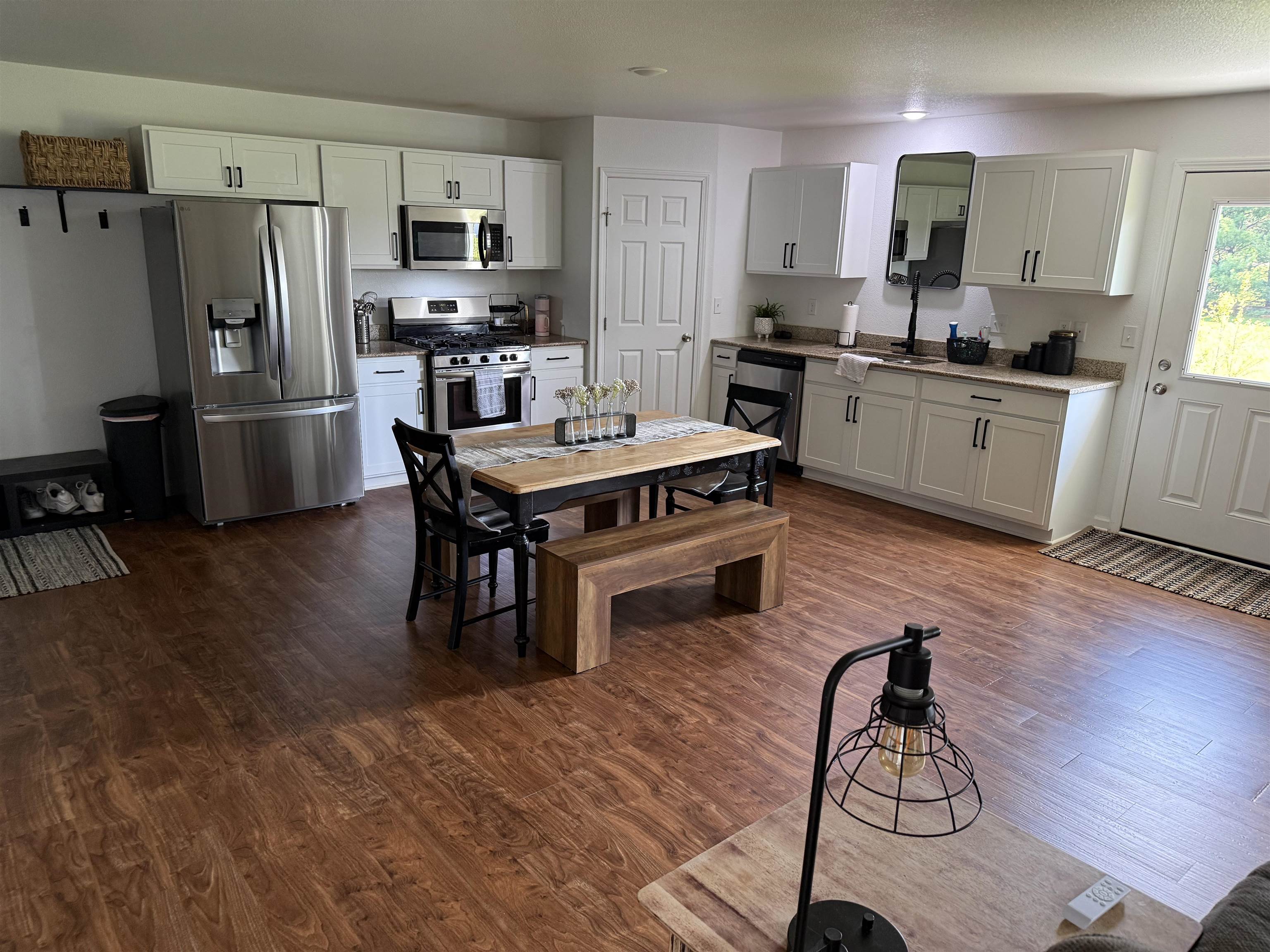 1135 Russell Road Belvidere, IL 61008 - Photo 6 of 11 a kitchen with stainless steel appliances a stove a sink a refrigerator and wooden floor