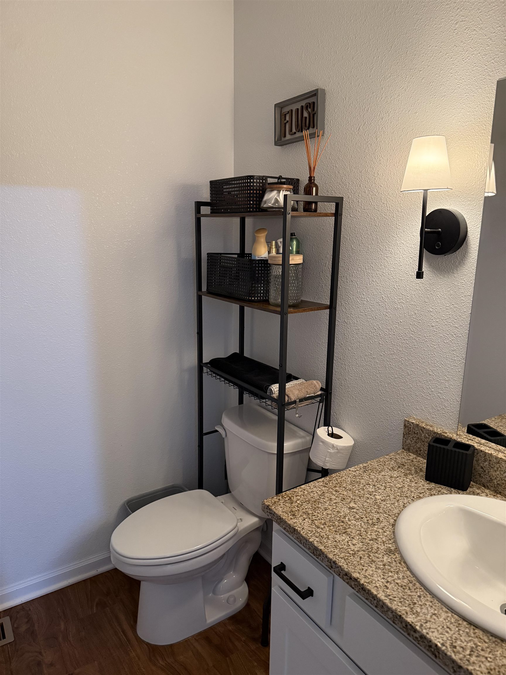 1135 Russell Road Belvidere, IL 61008 - Photo 7 of 11 a bathroom with a granite countertop toilet sink and mirror