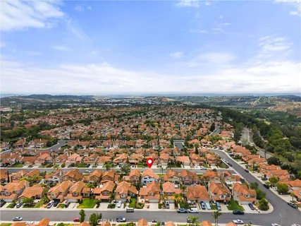 an aerial view of residential building and trees around