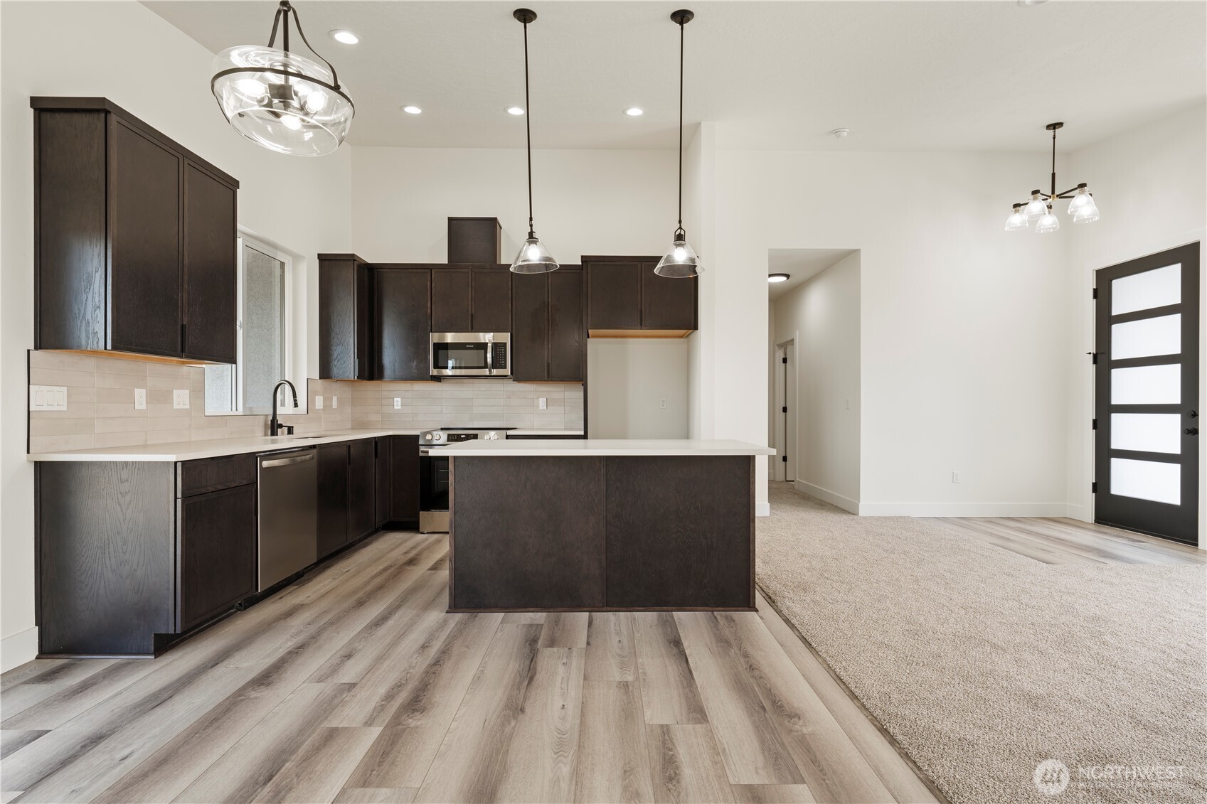 1101 E Mount Othello, WA 99344 - Photo 20 of 34 a large kitchen with kitchen island a sink stainless steel appliances and cabinets