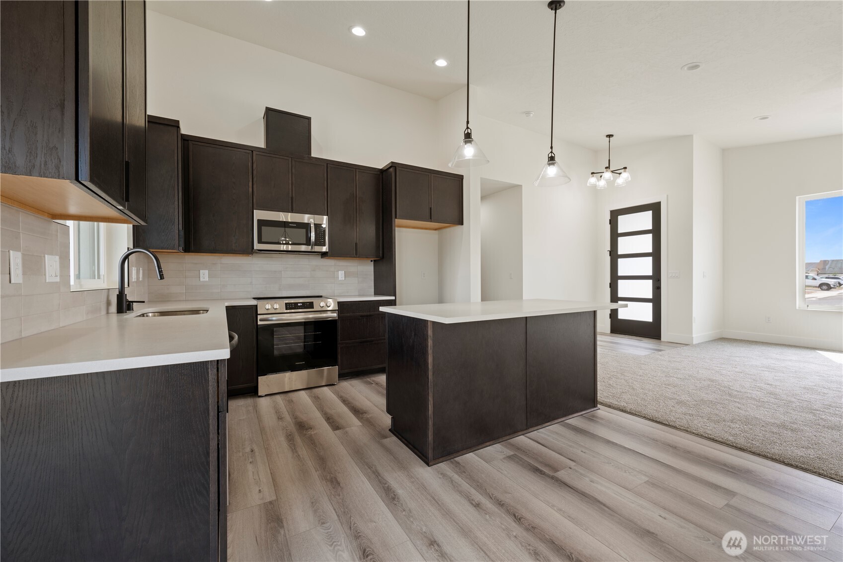 1101 E Mount Othello, WA 99344 - Photo 21 of 34 a large kitchen with stainless steel appliances a large counter top a stove and a sink