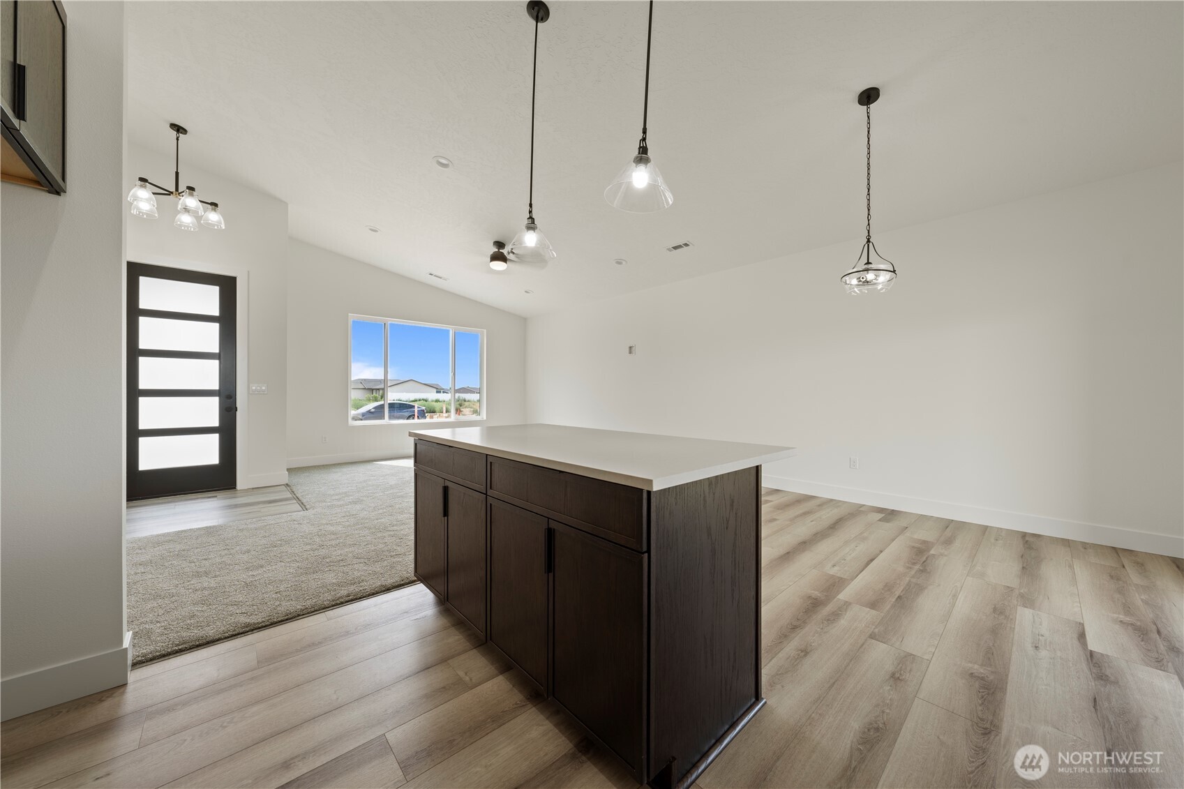 1101 E Mount Othello, WA 99344 - Photo 22 of 34 a kitchen with kitchen island a counter top space appliances and a ceiling fan