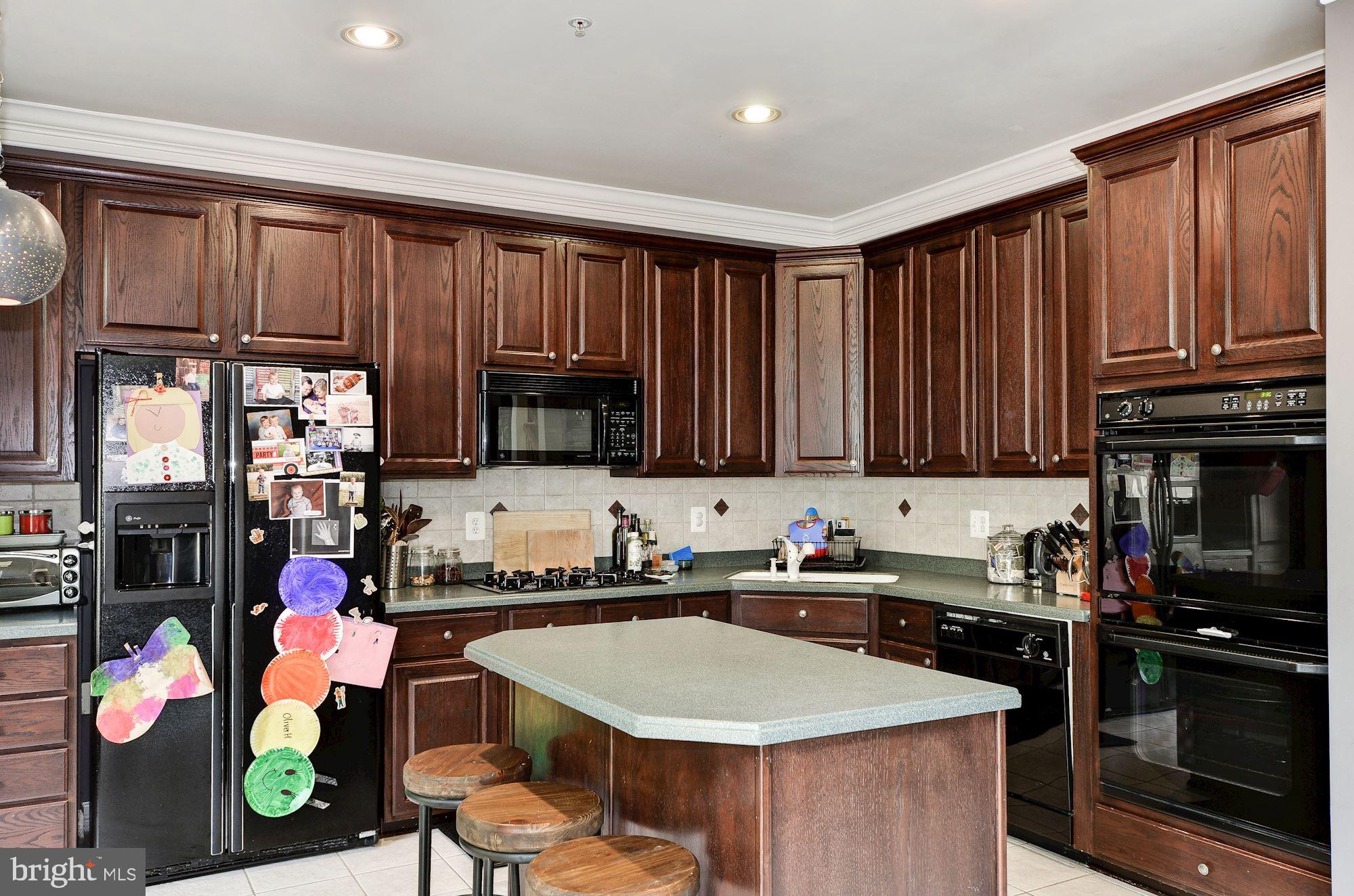 4908 Waple Lane Alexandria, VA 22304 - Photo 13 of 36 a kitchen with a sink a stove and cabinets