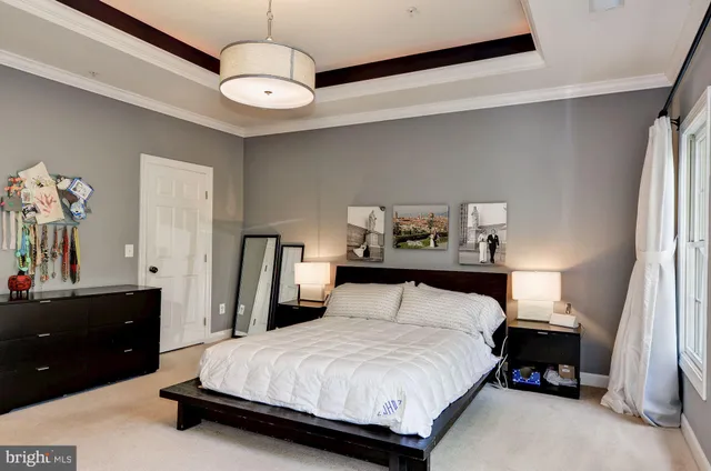 a bedroom with a bed and a night stand