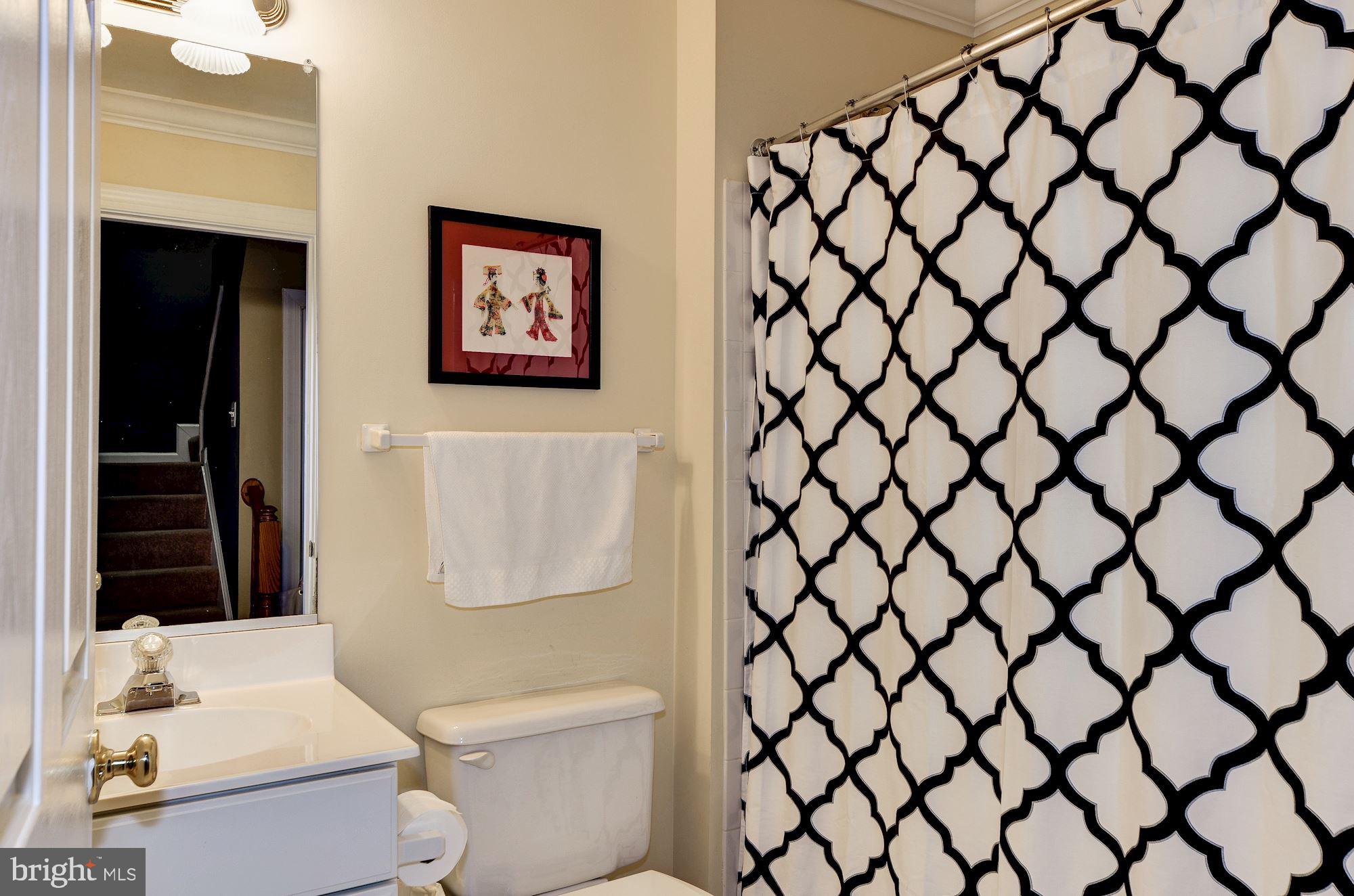 4908 Waple Lane Alexandria, VA 22304 - Photo 27 of 36 a white toilet sitting next to a bathroom sink