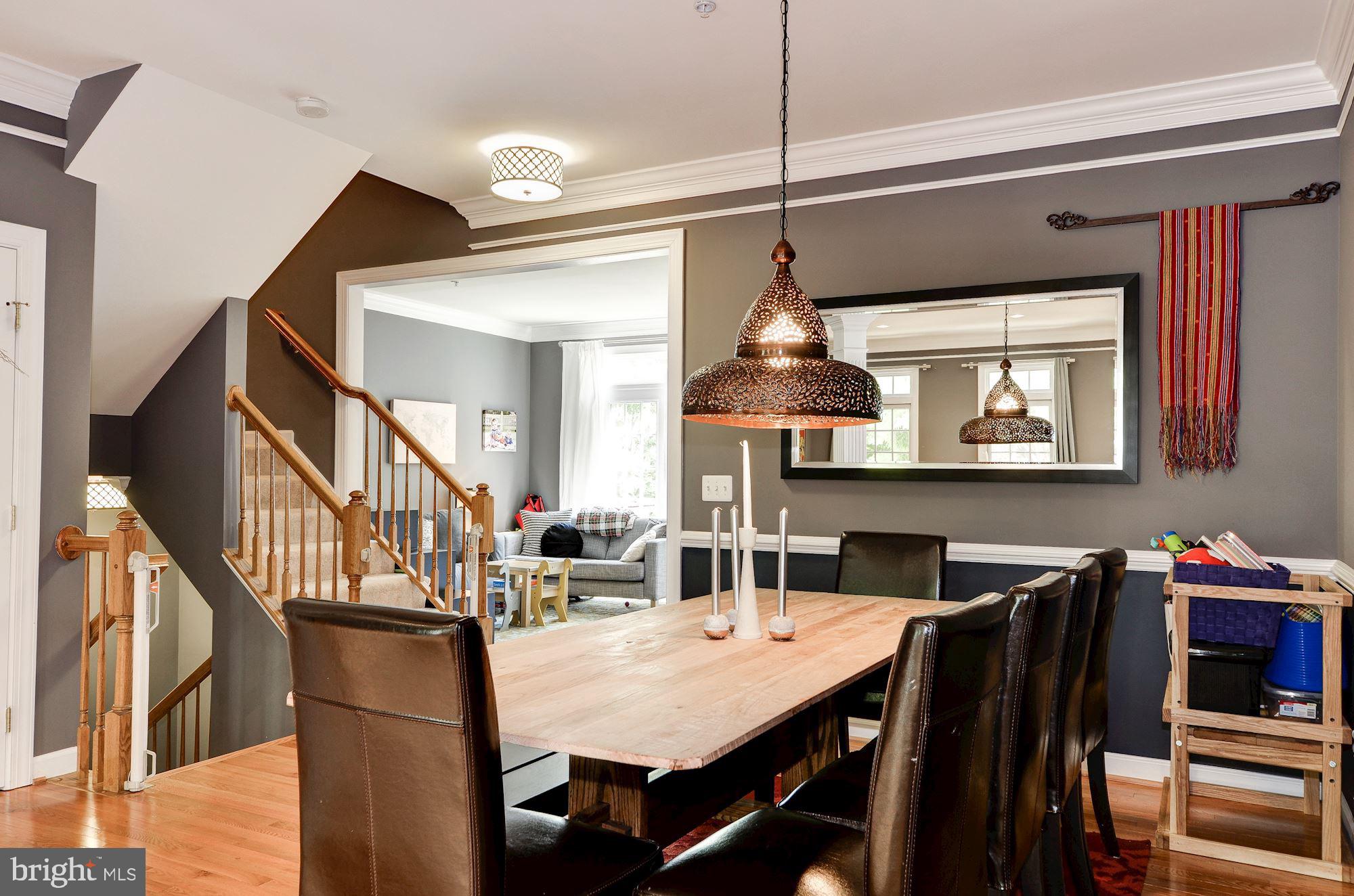 4908 Waple Lane Alexandria, VA 22304 - Photo 3 of 36 a view of a dining room and livingroom with furniture wooden floor a chandelier