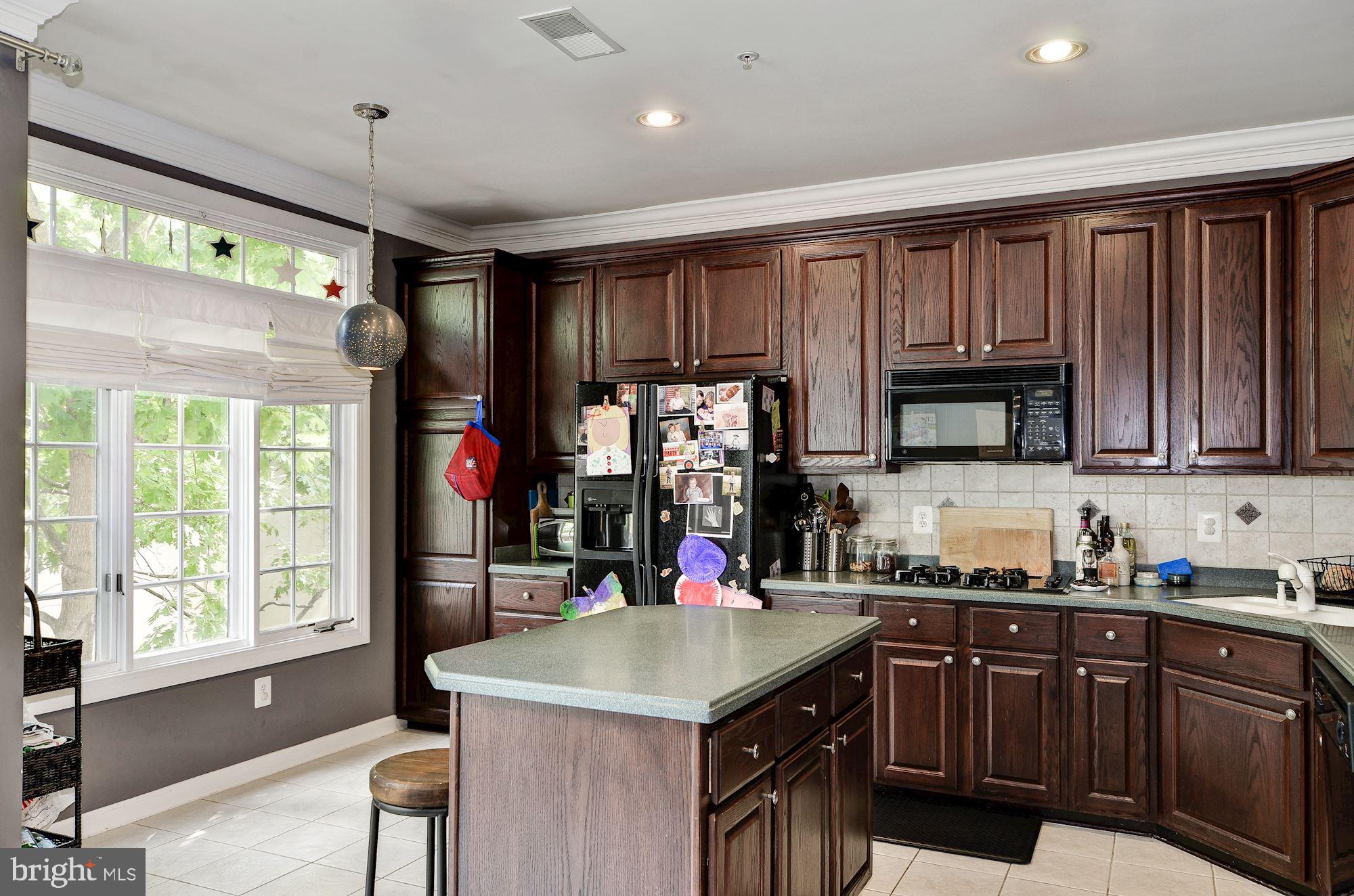4908 Waple Lane Alexandria, VA 22304 - Photo 5 of 36 a kitchen with stainless steel appliances granite countertop a refrigerator a sink dishwasher a stove and a refrigerator with wooden floor