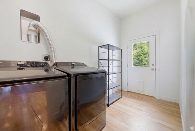 1389 Millbrook Way Bountiful, UT 84010 - Photo 54 of 74 Laundry area featuring wood-finish flooring, a white paneled door with a clear glass insert, and clean white walls