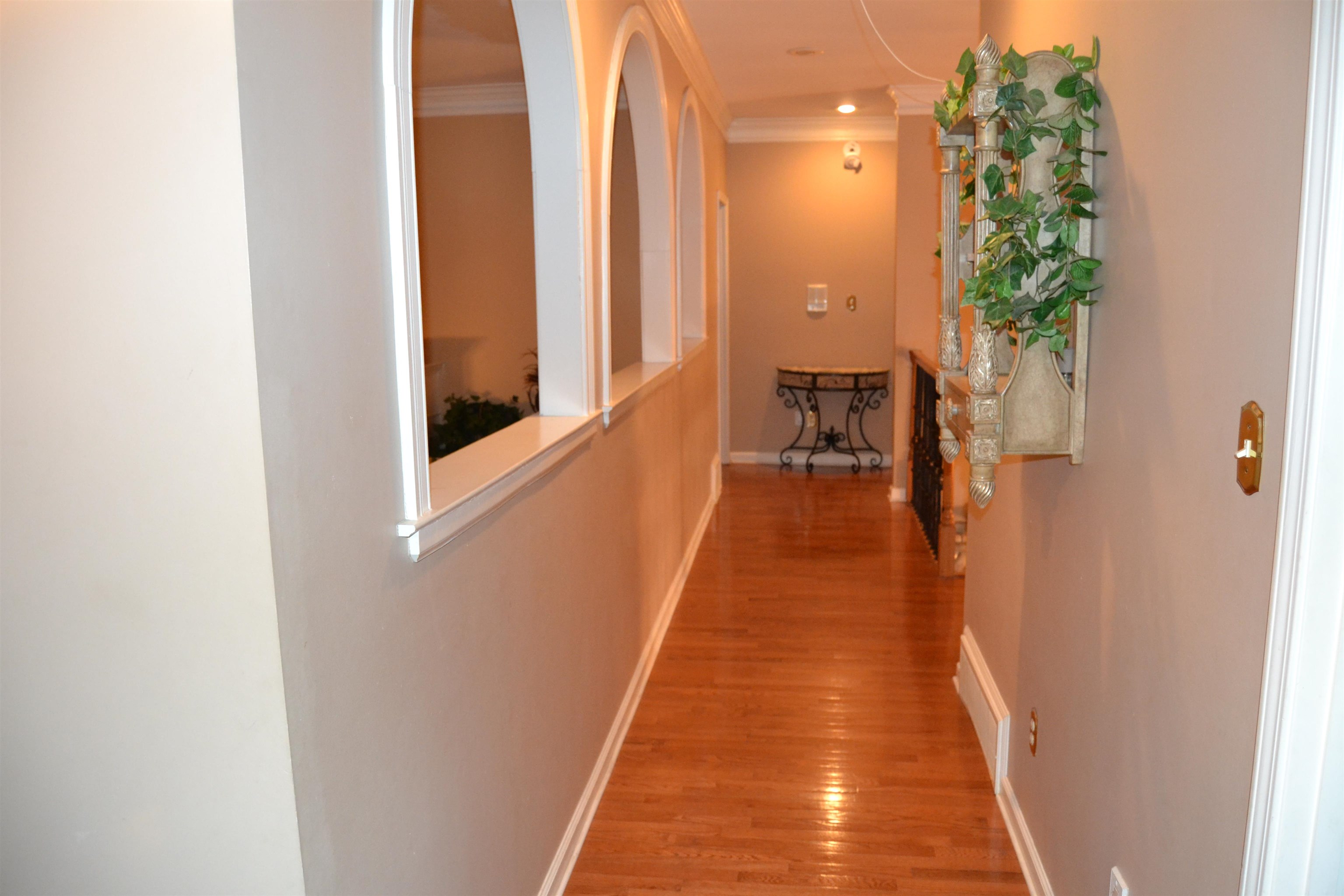 1364 Winoka Road Collierville, TN 38017 - Photo 18 of 25 a view of a hallway with wooden floor and a bathroom