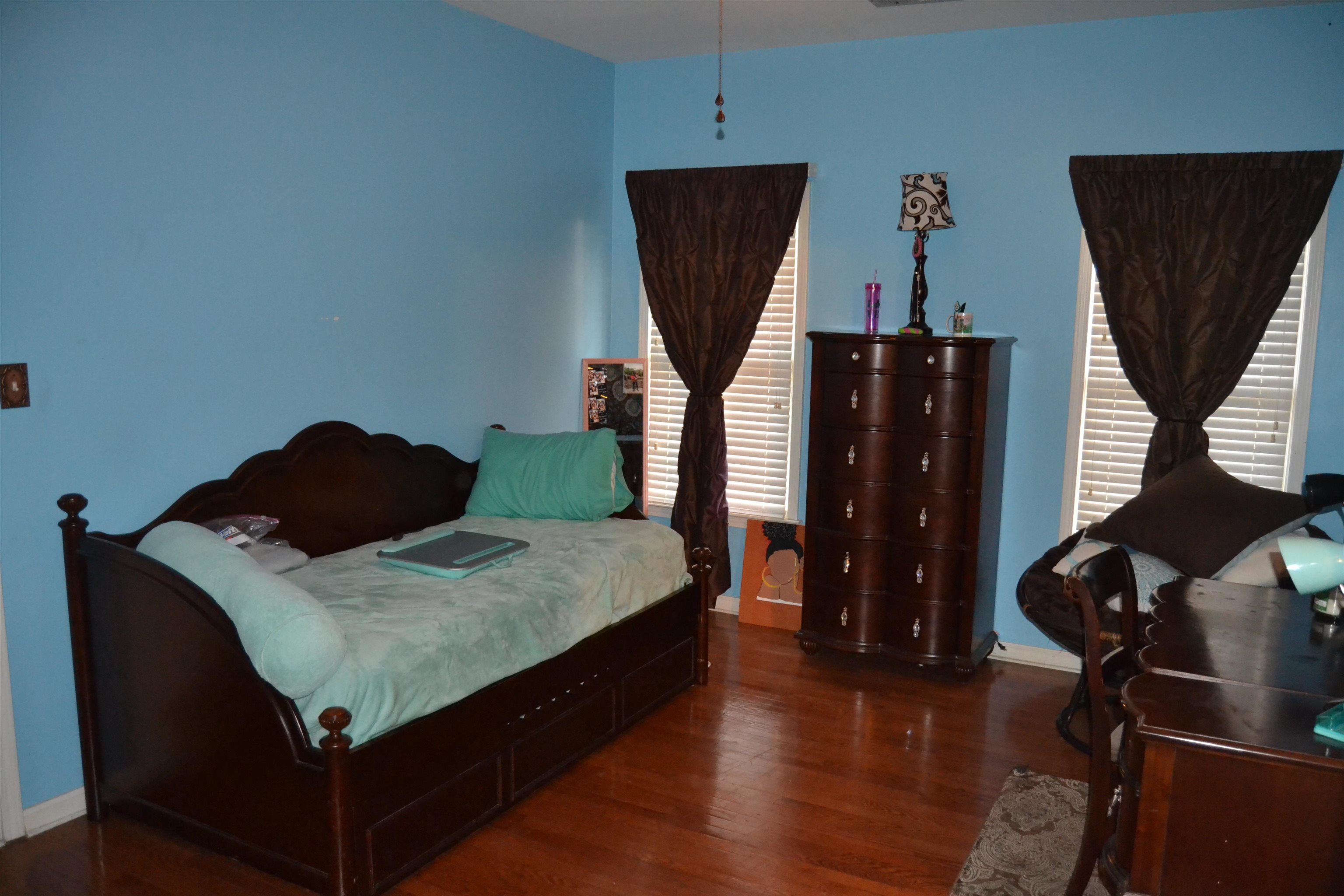 1364 Winoka Road Collierville, TN 38017 - Photo 22 of 25 a living room with furniture and a flat screen tv