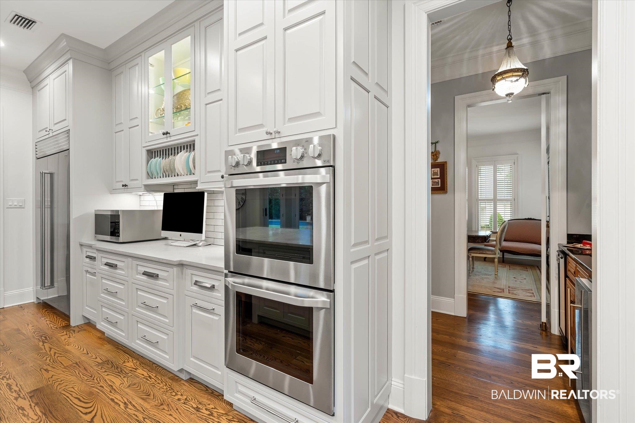 4008 McGregor Oaks Mobile, AL 36608 - Photo 15 of 50 Kitchen featuring appliances with stainless steel finishes, light wood-style floors, white cabinetry, light countertops, and recessed lighting