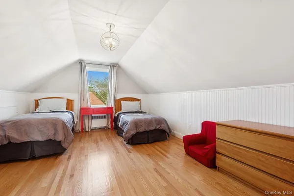 a bedroom with two beds and a chandelier