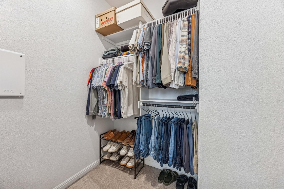 9015 Cattle Baron Path, Unit 1002 Austin, TX 78747 - Photo 12 of 21 a view of walk in closet with clothes and shoes
