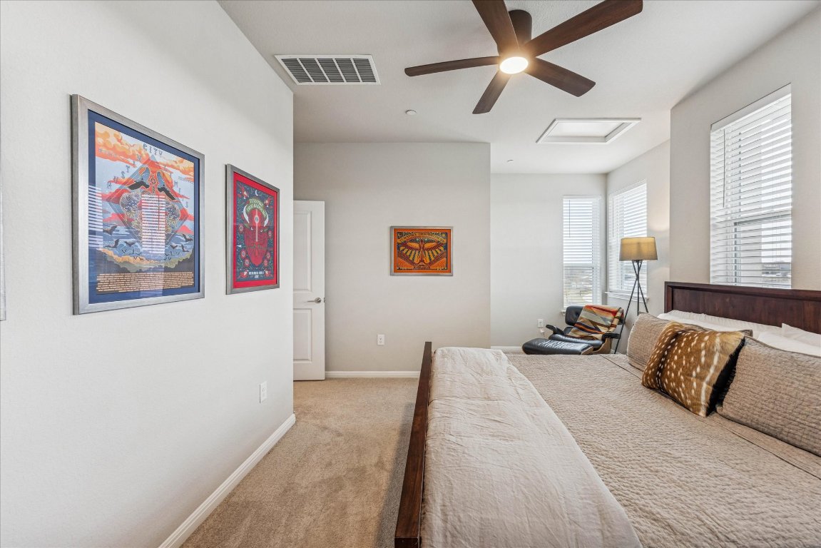 9015 Cattle Baron Path, Unit 1002 Austin, TX 78747 - Photo 14 of 21 a bedroom with a bed and wall painting