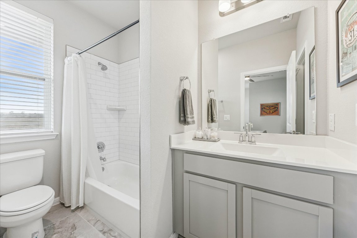 9015 Cattle Baron Path, Unit 1002 Austin, TX 78747 - Photo 15 of 21 a bathroom with a sink toilet vanity granite shower and bathtub