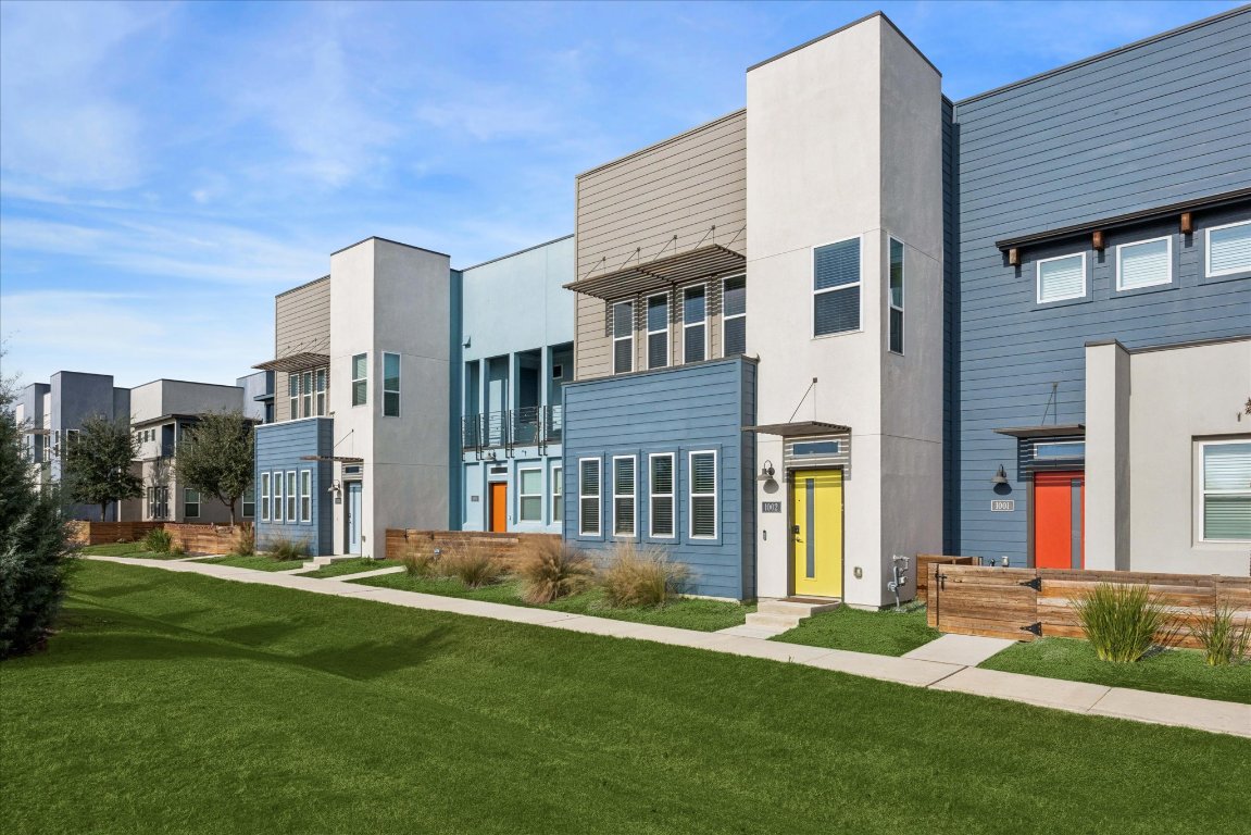 9015 Cattle Baron Path, Unit 1002 Austin, TX 78747 - Photo 19 of 21 a front view of a building with a garden
