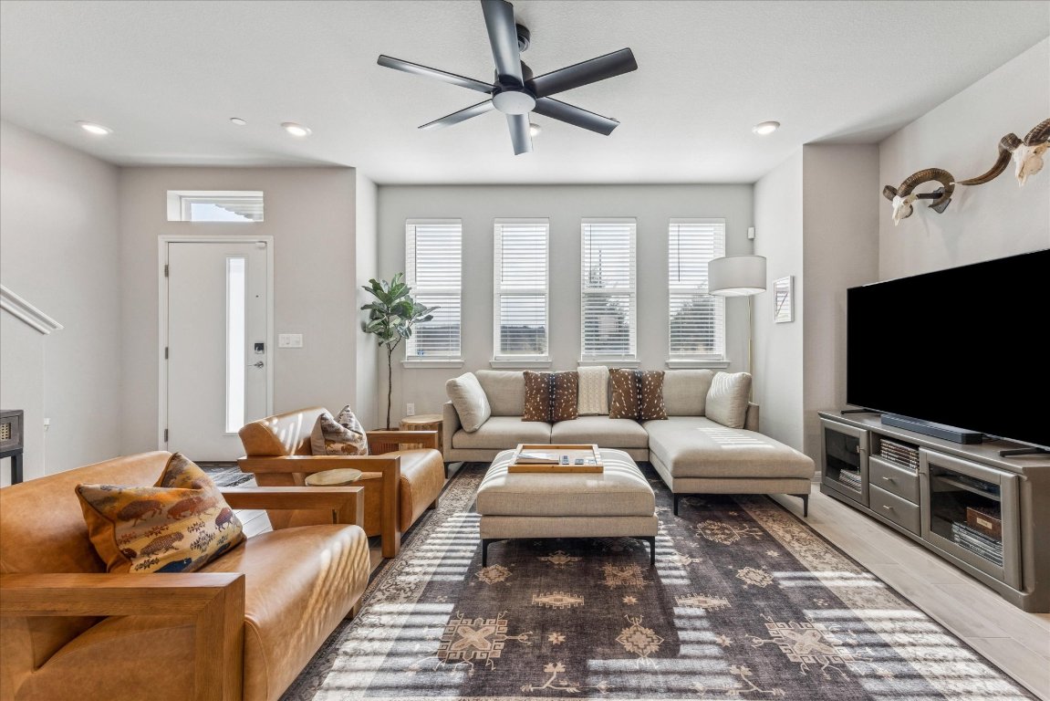 9015 Cattle Baron Path, Unit 1002 Austin, TX 78747 - Photo 3 of 21 a living room with furniture and a flat screen tv