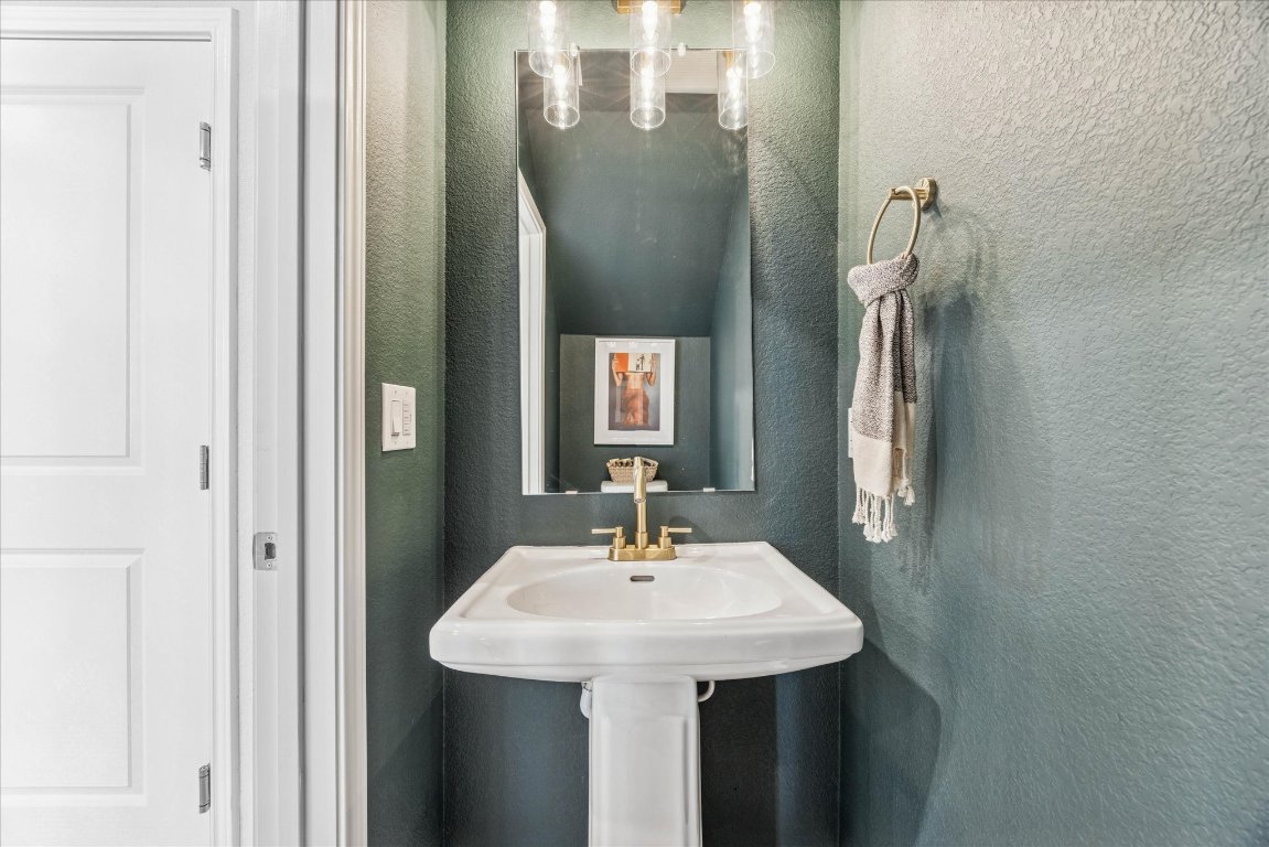 9015 Cattle Baron Path, Unit 1002 Austin, TX 78747 - Photo 8 of 21 a bathroom with a sink and a mirror