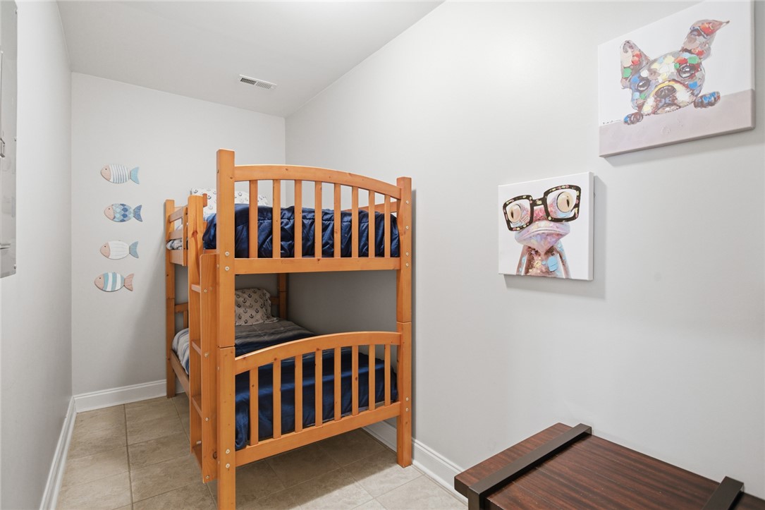 578 Sunset Point Drive West Union, SC 29696 - Photo 25 of 46 This cozy bedroom features a bunk bed and tiled flooring, offering a comfortable and practical living space.