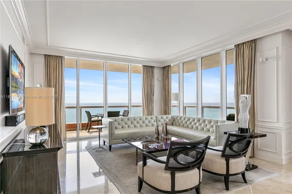 a living room with furniture and a large window