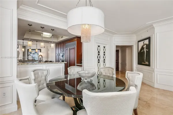 a dining room with furniture and a chandelier